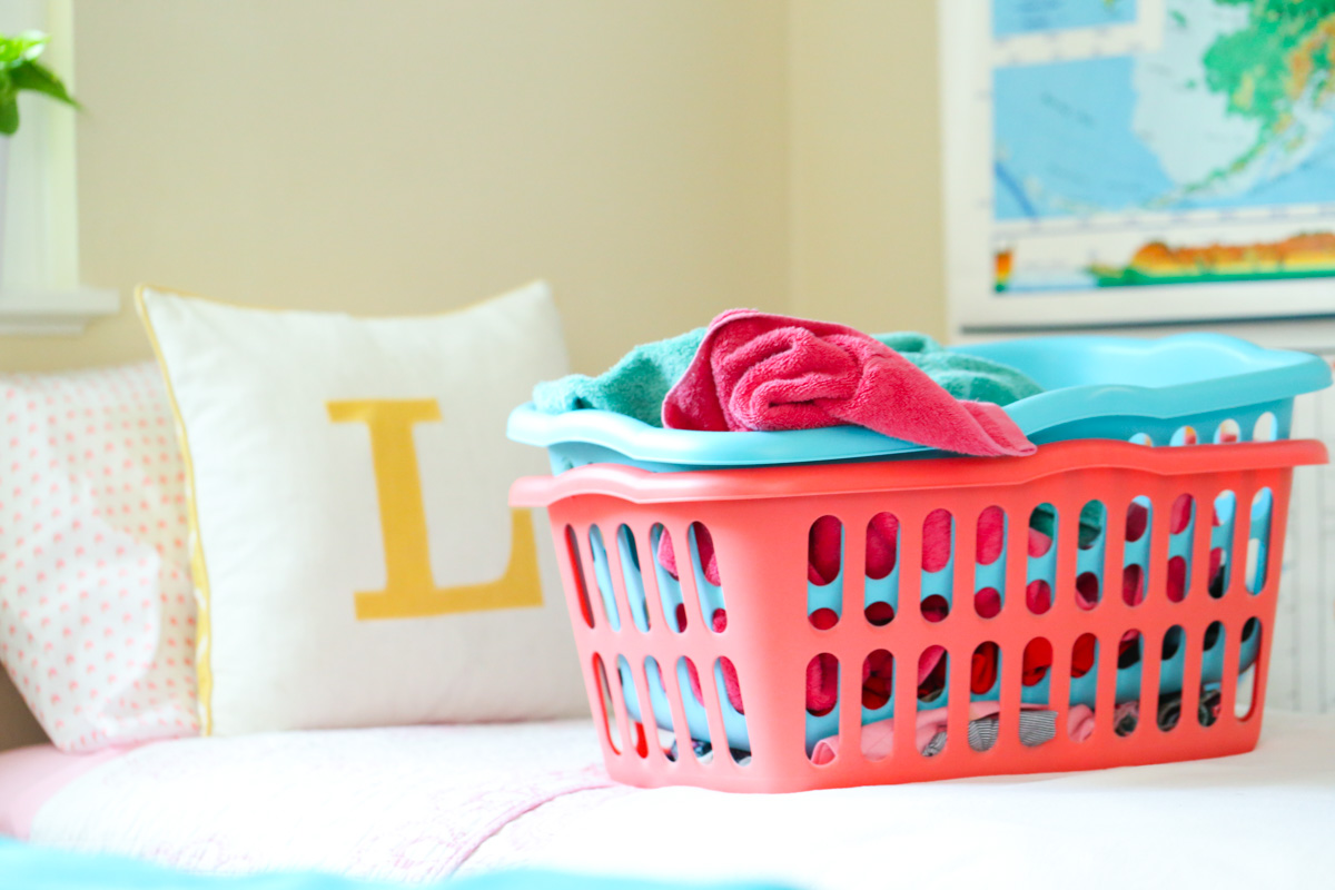 Towels on the bed in a laundry basket ready to be washed.
