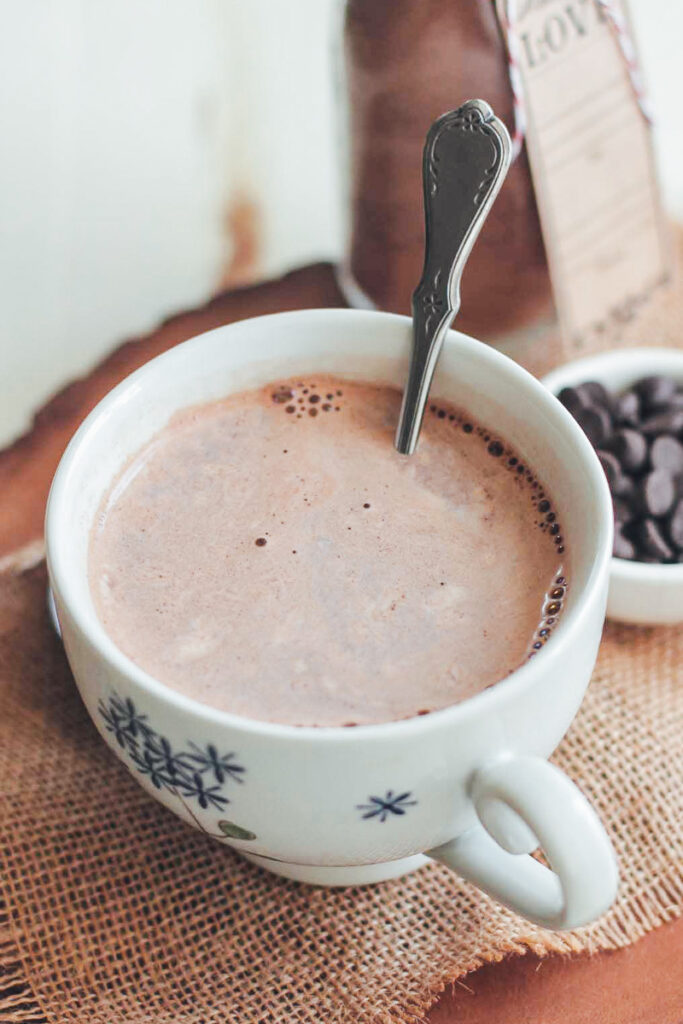 Homemade chocolate in a mug with a spoon.