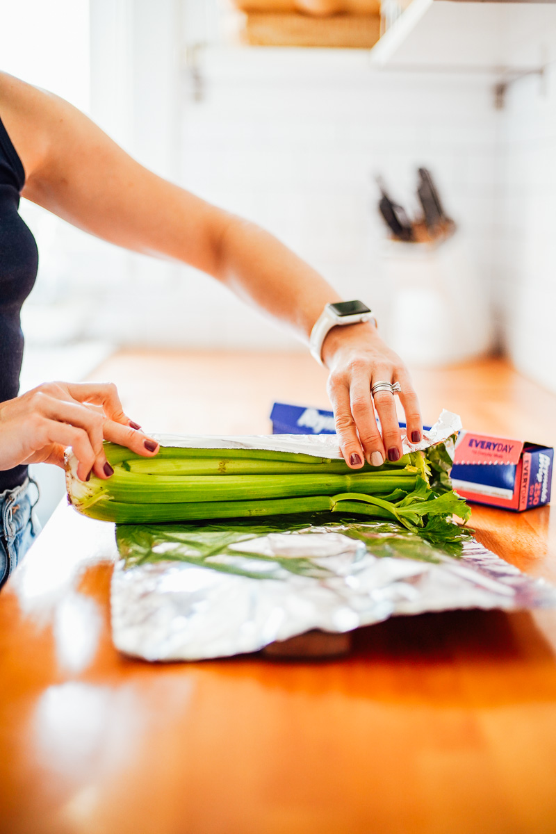 Wrapping whole celery in foil to keep it fresh. 