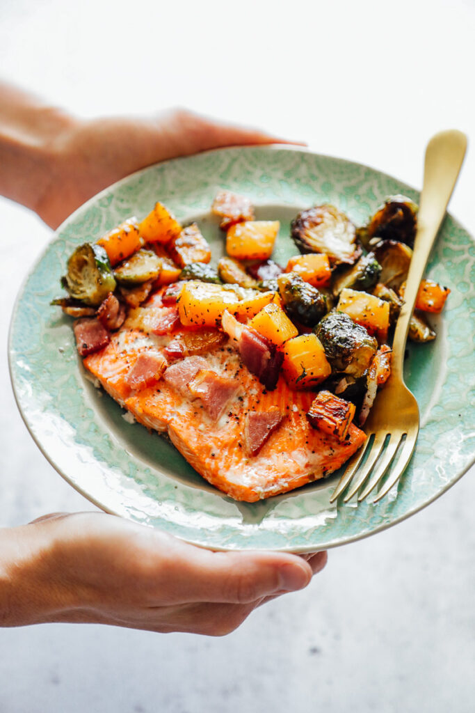 Salmon on a plate with brussels sprouts and butternut squash