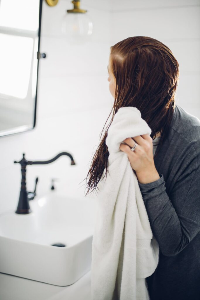 Drying wet hair with a towel.